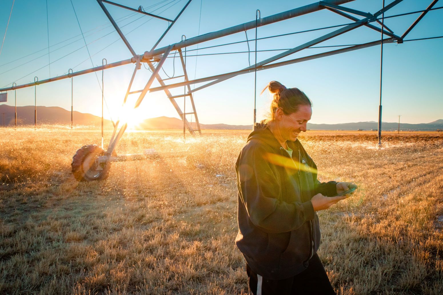 Nevada farmer Denise Moyle in her alfalfa fields. Credits: NASA/courtesy of Glow by G Photography