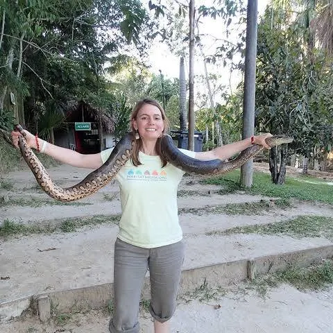 woman holding a snake outdoors