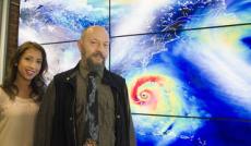 NASA tropical meteorologists Marangelly Fuentes, left, and Oreste Reale pose with a hyperwall display of the Global Modeling and Assimilation Office's simulation of a hurricane. Credits: NASA/Goddard/Deb McCallum